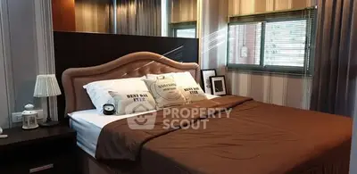 Cozy bedroom with elegant decor and plush bedding, perfect for relaxation.