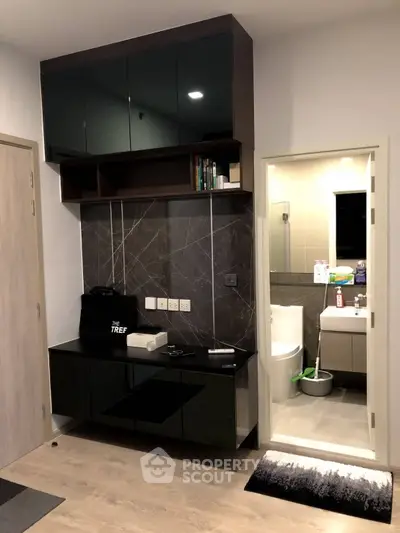 Modern apartment interior with sleek storage and bathroom view