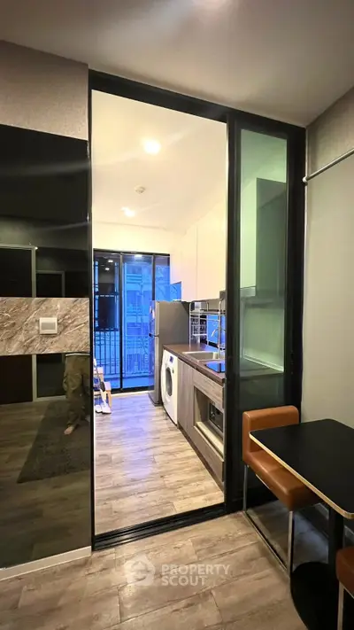 Modern kitchen with sleek appliances and open layout in stylish apartment