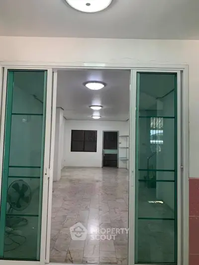 Spacious interior with sliding glass doors and marble flooring, ideal for modern living.