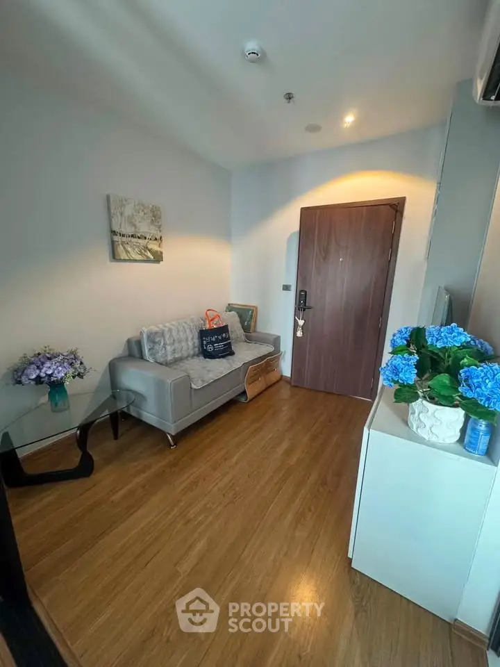 Cozy living room with modern decor and wooden flooring in a stylish apartment.