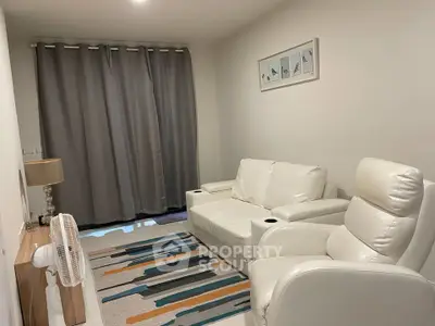 Cozy living room with white leather seating and modern decor