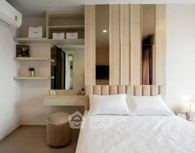 Modern bedroom with stylish decor and built-in shelves, featuring a cozy bed and elegant lighting.