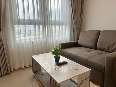 Modern living room with cozy sofa and elegant coffee table near large window.
