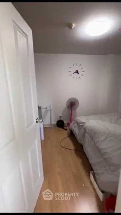 Cozy bedroom with wooden flooring and minimalist decor