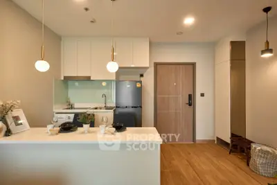 Modern kitchen with sleek design, featuring an open layout and stylish lighting, perfect for contemporary living.