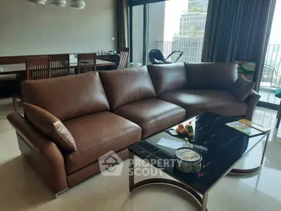 Luxurious living room with elegant brown leather sofa and chic black marble coffee table, perfect for modern living.