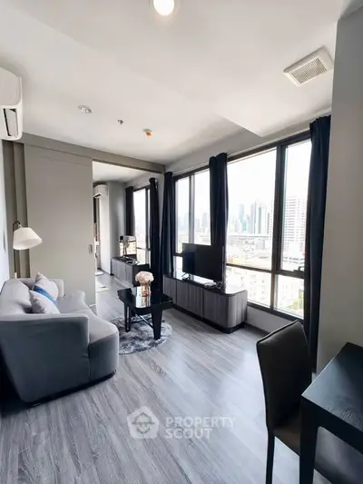 Modern living room with panoramic city view, sleek furniture, and abundant natural light.