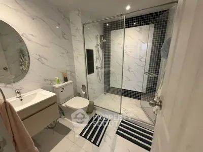 Modern bathroom with glass shower and marble tiles