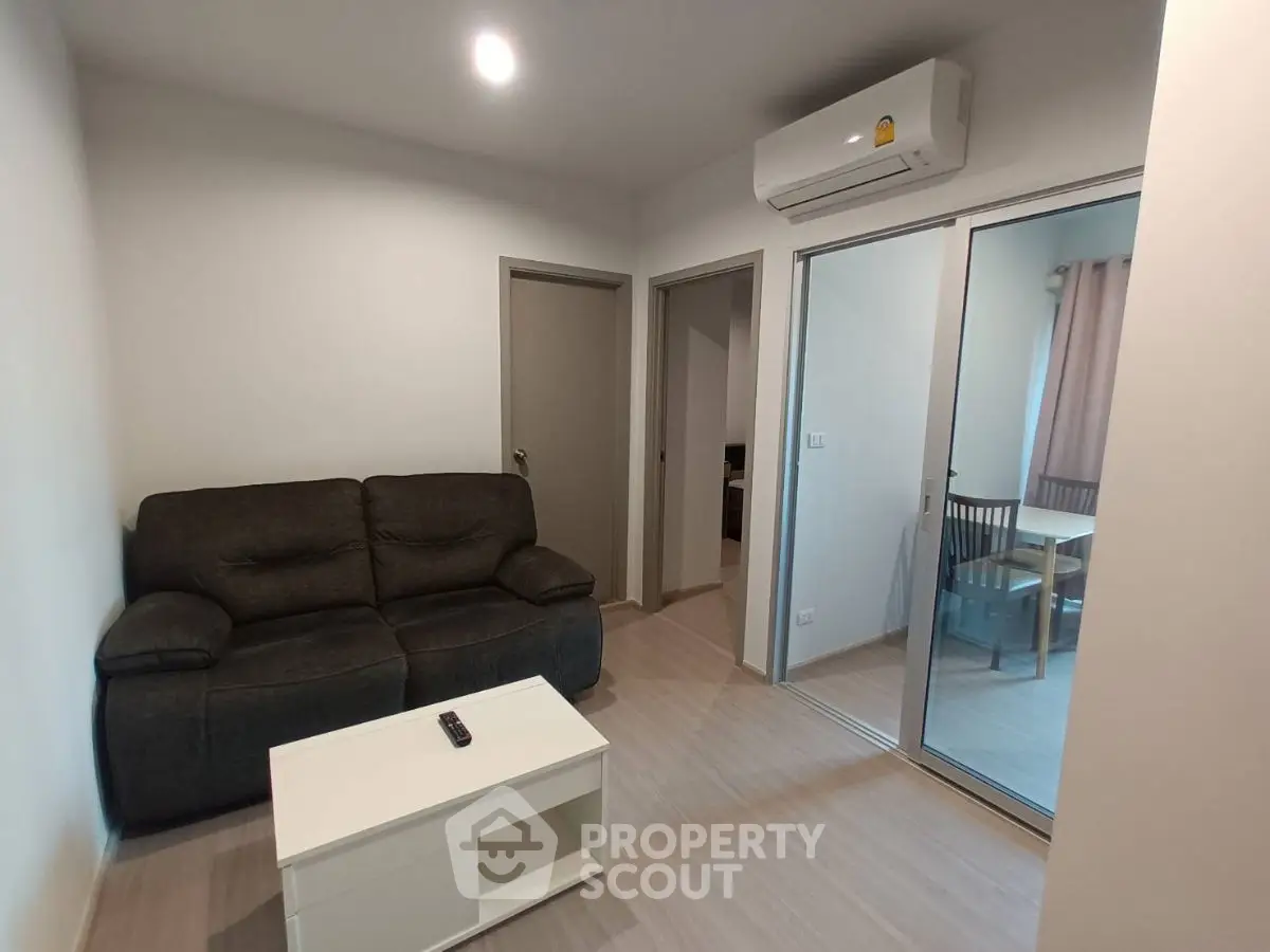 Modern living room with cozy sofa and air conditioning in a stylish apartment.