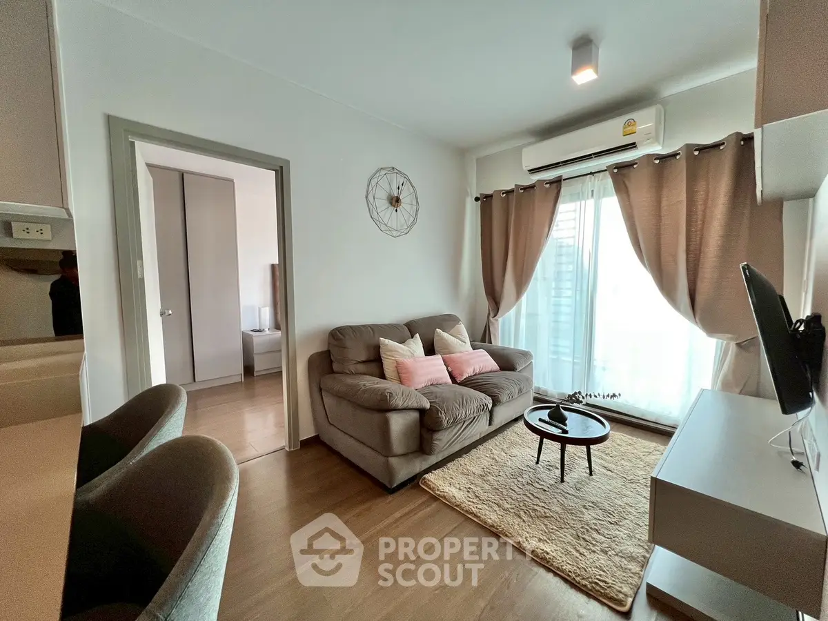 Cozy living room with modern decor and natural light, featuring a plush sofa and stylish accents.