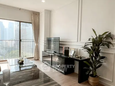 Modern living room with city view, elegant decor, and stylish furniture in a high-rise apartment.