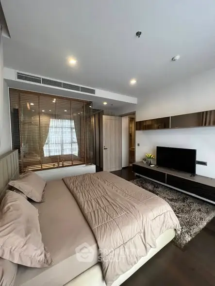 Modern bedroom with stylish decor and cozy ambiance in a luxury apartment.