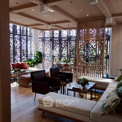 Luxurious modern living room with stylish decor and ample natural light.