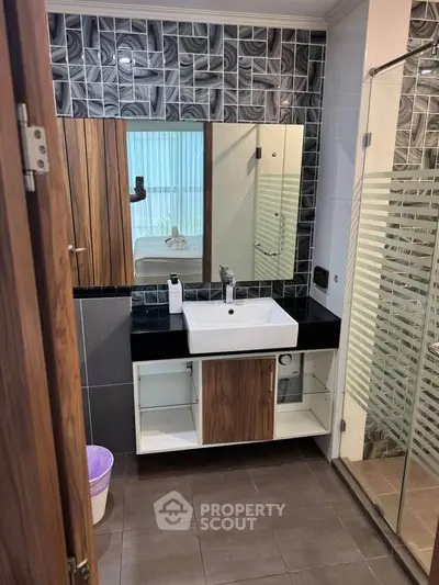 Modern bathroom with stylish tiles and sleek vanity unit