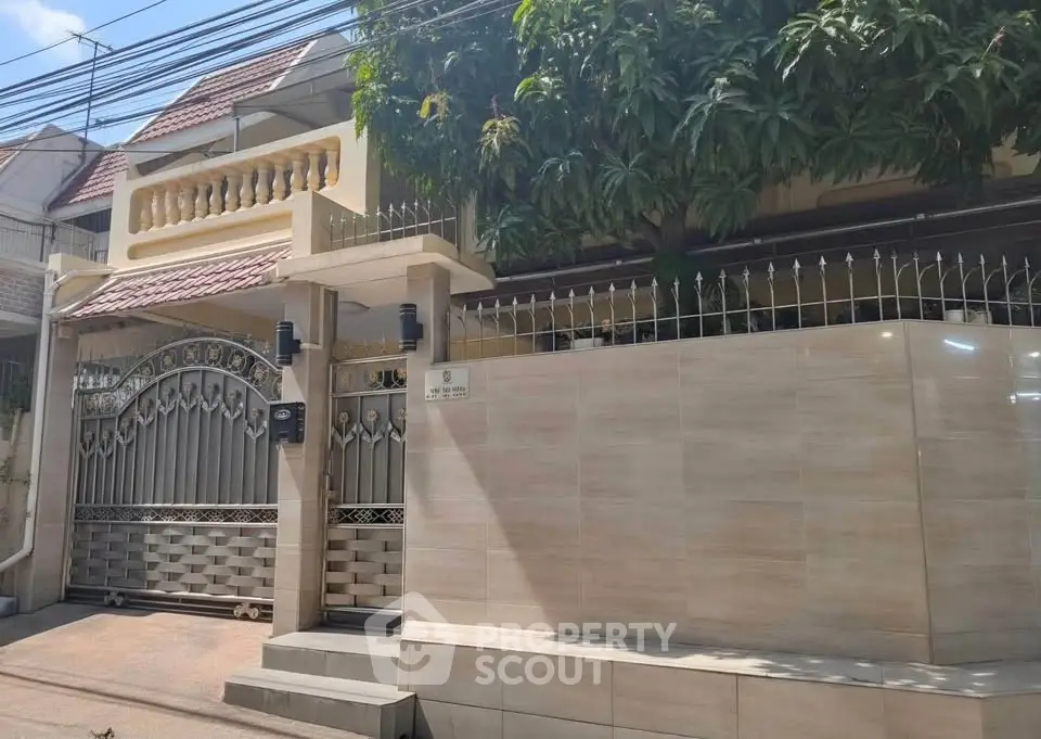 Charming residential property with gated entrance and lush greenery, perfect for privacy and tranquility.