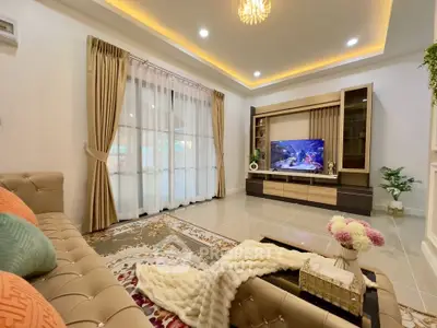 Luxurious living room with elegant decor, plush seating, and modern entertainment center.