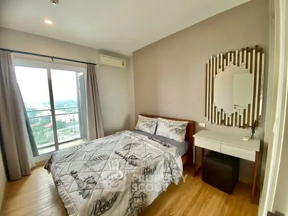Cozy bedroom with city view, featuring modern decor and ample natural light.