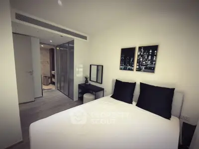 Modern bedroom with ensuite bathroom and stylish decor in a contemporary apartment.
