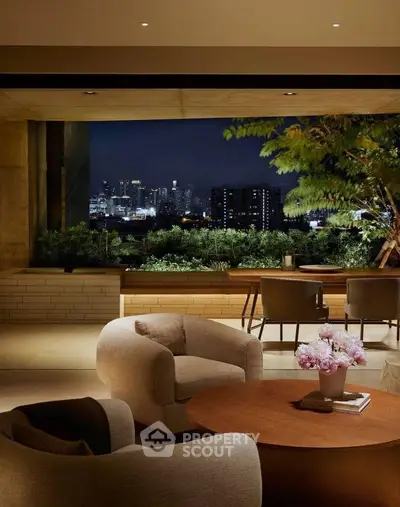 Luxurious living room with stunning city view and elegant decor at night.