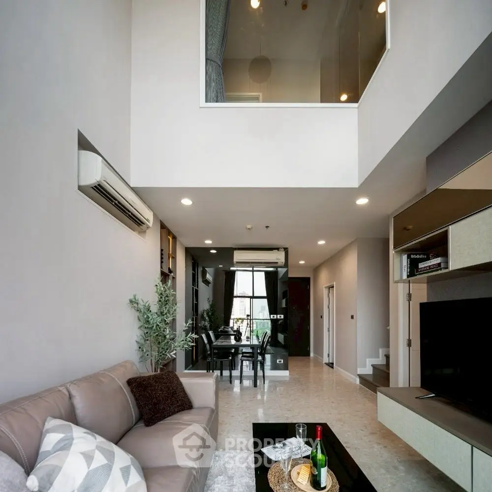 Spacious modern living room with high ceiling and elegant decor