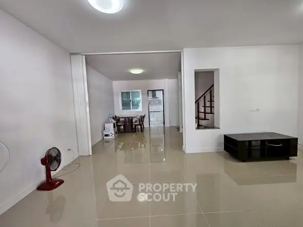 Spacious living area with glossy tiled floors and modern decor