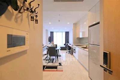 Modern open-layout kitchen and living area with sleek design and natural light.