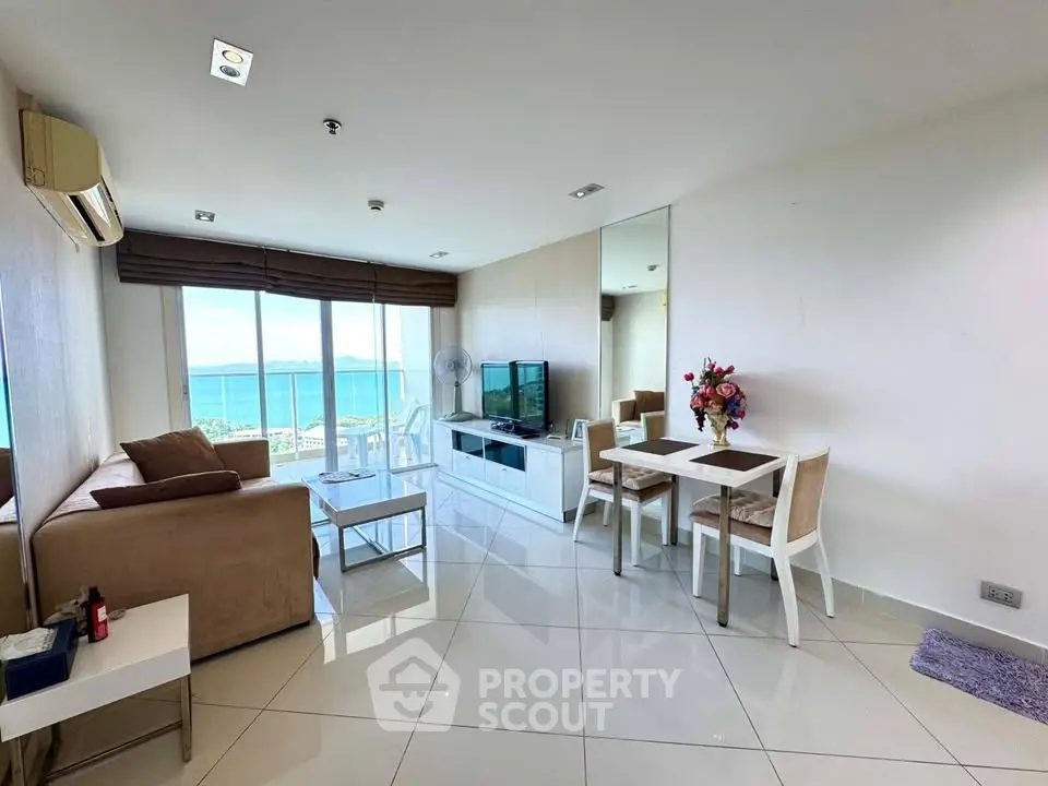 Stunning living room with ocean view, modern furniture, and elegant decor in a high-rise apartment.
