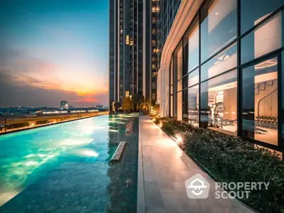 Luxurious high-rise building with stunning rooftop pool and city view at sunset