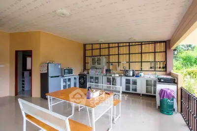 Spacious open-layout kitchen with modern appliances and outdoor dining area, perfect for entertaining.