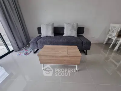 Modern living room with sleek sofa and stylish coffee table, perfect for contemporary living.