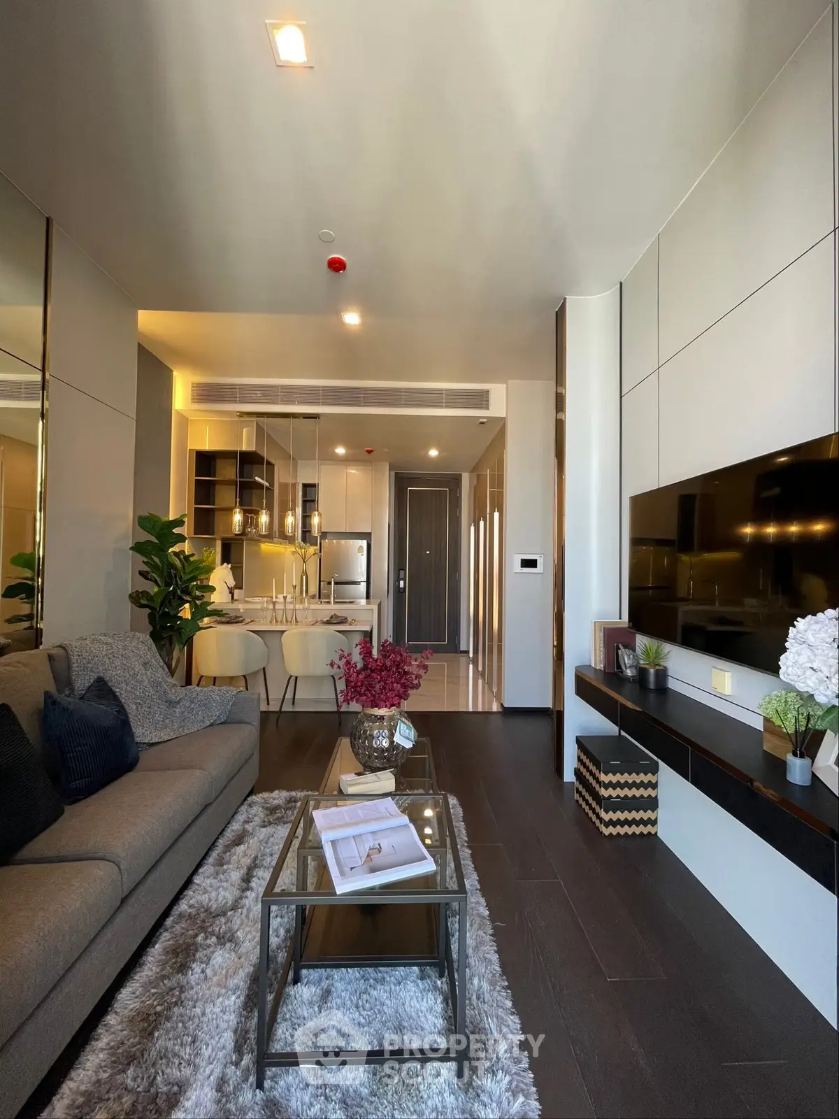 Luxurious modern living room with elegant decor and open kitchen layout, perfect for stylish urban living.