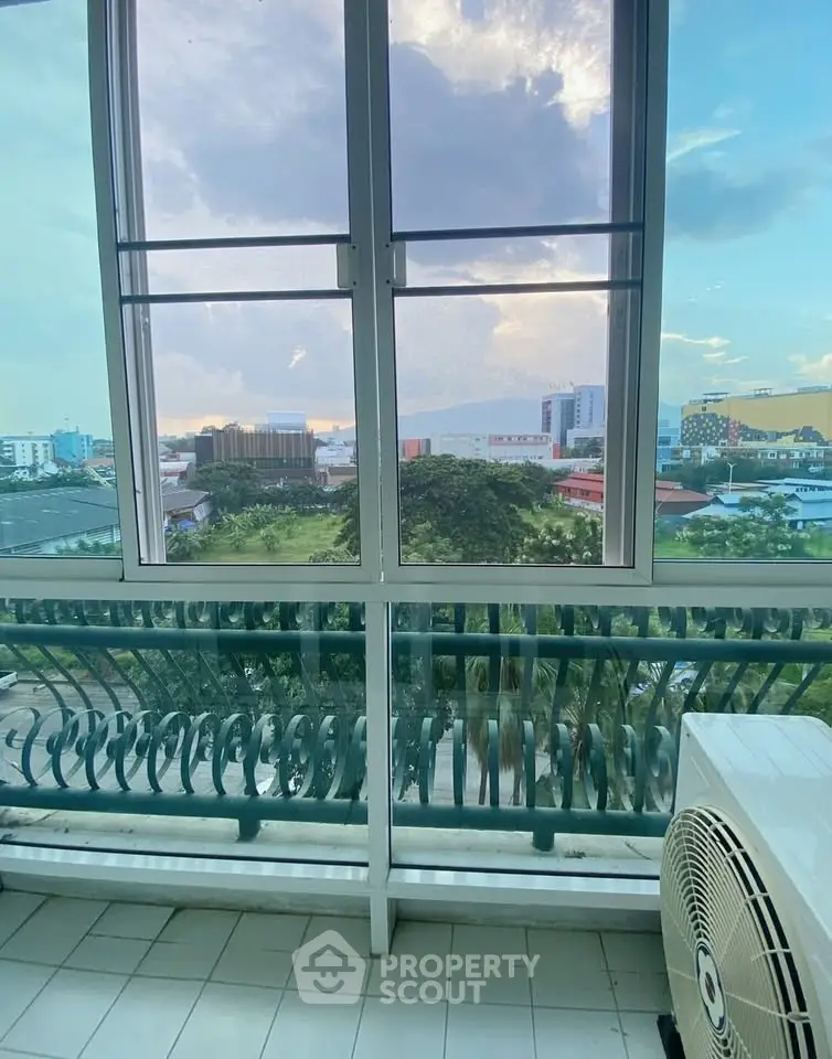 Stunning cityscape view from a modern balcony with lush greenery and skyline.