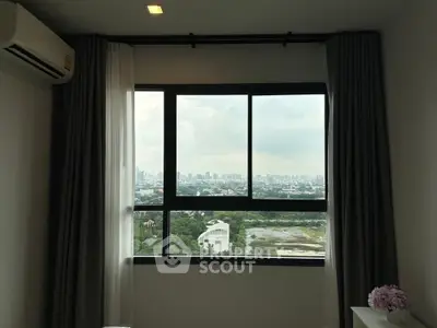 Modern bedroom with large window offering stunning cityscape view