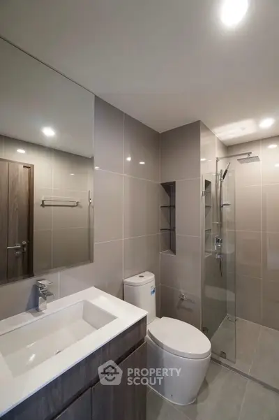 Modern bathroom with sleek fixtures and glass shower enclosure