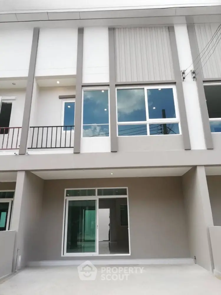 Modern townhouse exterior with large windows and sleek design