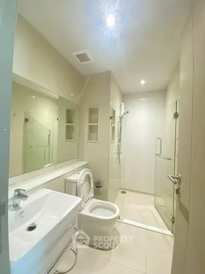 Modern bathroom with glass shower and sleek fixtures