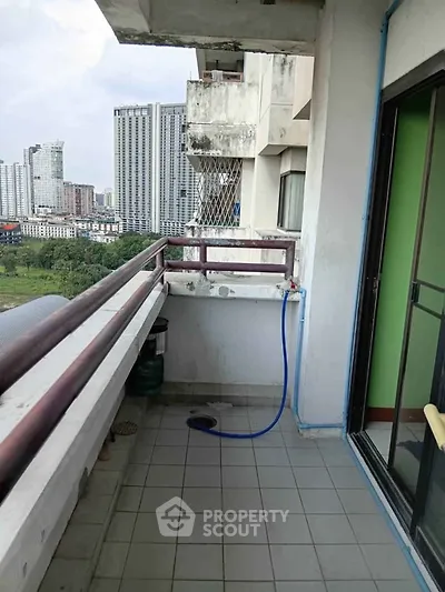 Spacious balcony with city view in high-rise apartment