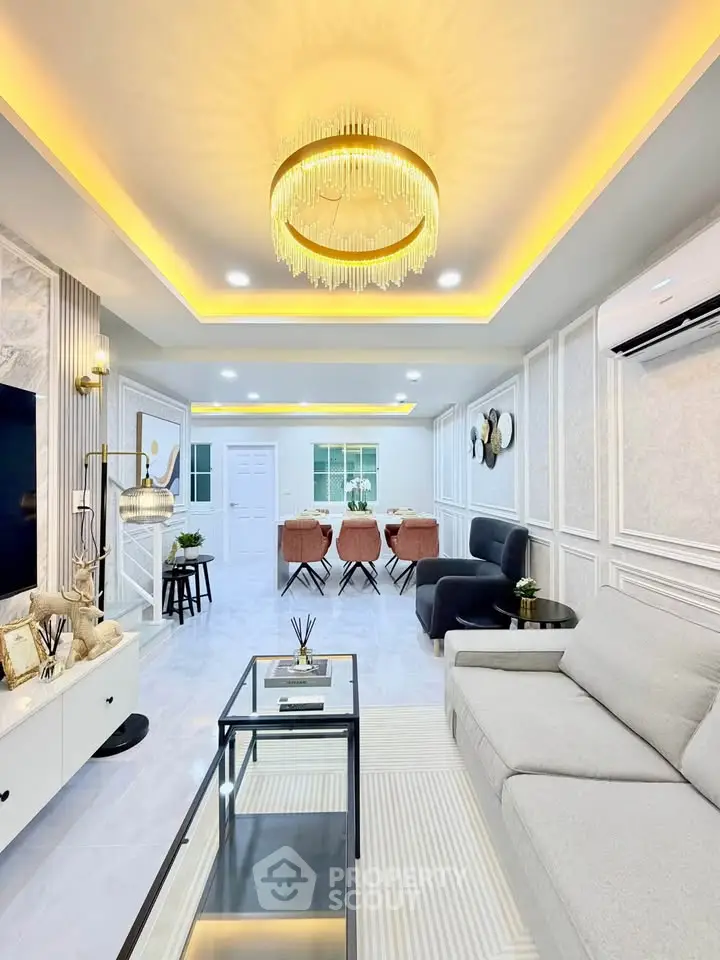 Luxurious modern living room with elegant chandelier and stylish decor