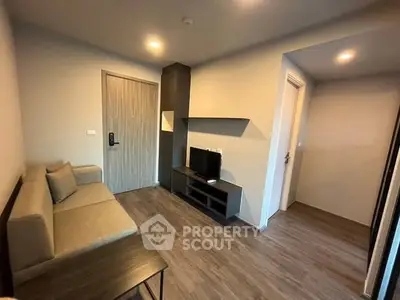 Modern living room with cozy sofa and sleek TV unit in stylish apartment.