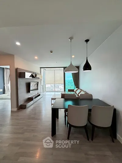 Spacious modern living room with stylish furniture and large windows offering a stunning view.