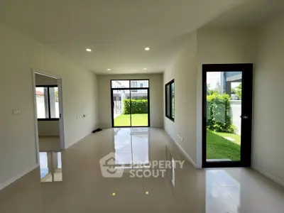 Spacious modern living room with large windows and garden view