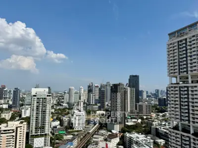 Stunning cityscape view showcasing modern high-rise buildings under a clear blue sky.