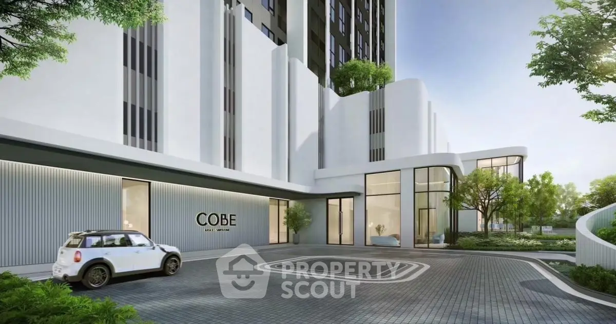 Modern luxury apartment building entrance with sleek design and lush greenery