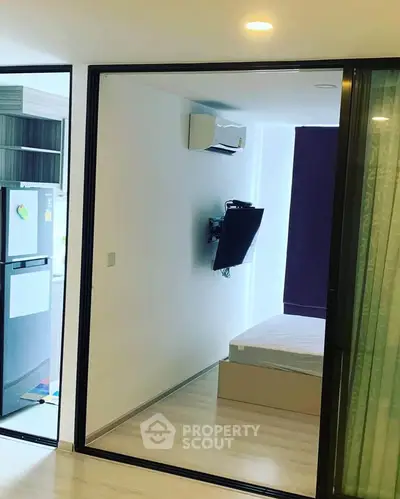 Modern apartment interior with sleek design and open layout, featuring a cozy bedroom and stylish kitchen.