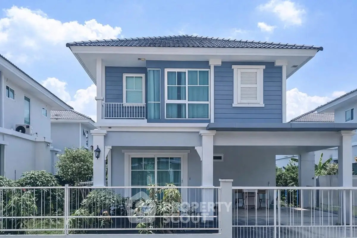 Charming two-story house with modern facade and spacious driveway in a serene neighborhood.