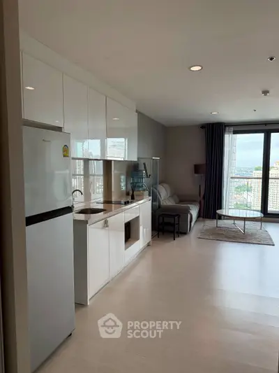 Modern open-plan living room with kitchen and city view balcony