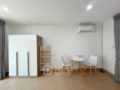 Modern minimalist living room with sleek furniture and air conditioning