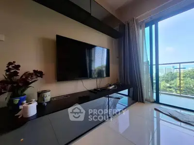 Modern living room with sleek TV setup and balcony view