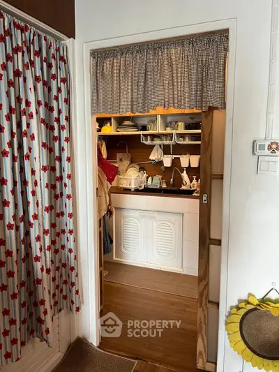 Charming kitchen with open shelving and cozy curtain accents, perfect for a warm and inviting home.